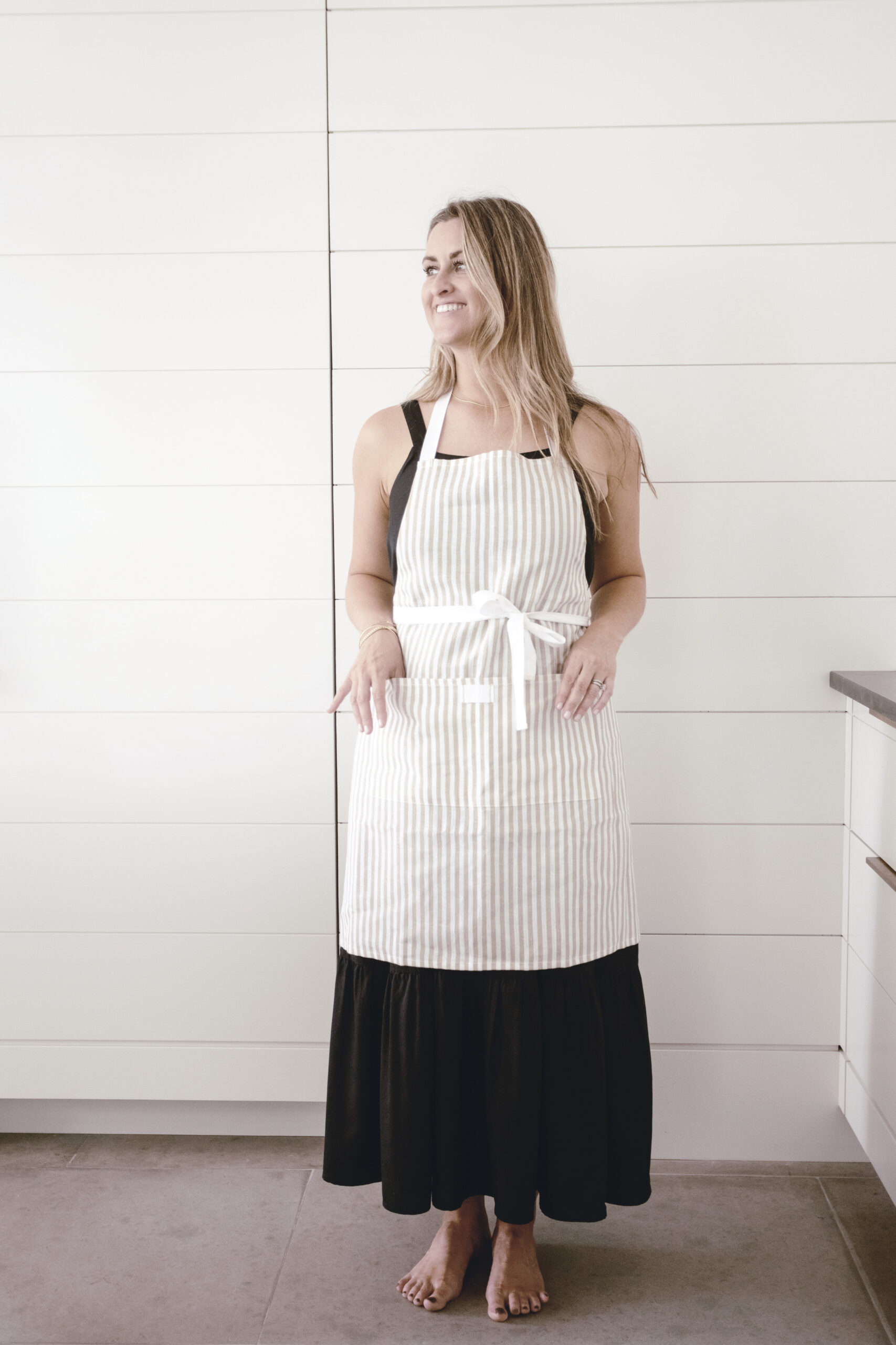 woman wearing a striped bistro apron