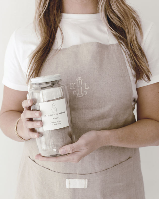 The Keepsake Jar Apron. ​​​​​​​​​
Our very first product, reimagined and available once again to add to your home as a future family heirloom. 

Available in adult & child sizes and complete with a linen apron, blank recipe cards, & an Heirloomed Swatch Kit, the Keepsake Jar Apron aids you in experiencing the lost art of archiving memories together in the kitchen. 

Handwrite your favorite recipes onto the blanks recipe cards from your jar and add them to your stack of old, splattered recipe cards you've inherited. 

Hand-stitch your initials onto the Heirloomed Swatch provided. Have your family members and others who have inspired you in the kitchen stitch theirs as well. Tack the swatch into the apron and keep it to pass down through generations alongside your tried-&-true family recipes. 

Create the most meaningful family heirloom with our Keepsake Jar Apron.